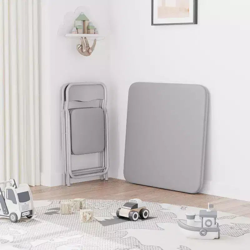 Ensemble table et deux chaises pliantes pour enfants, avec coussins en PU, facile à ranger, idéal pour les repas, la lecture et les jeux des enfants.
